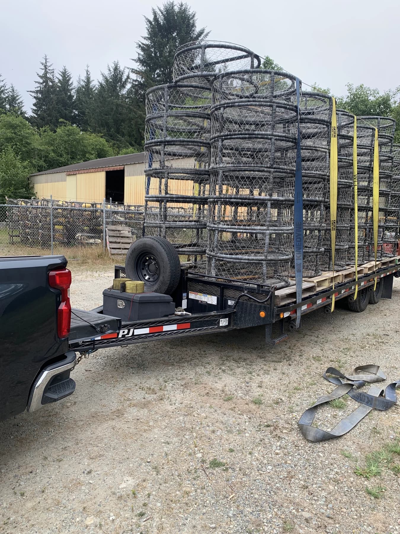 Flatbed trailer loaded with stacks of finished CCP crab pots strapped for delivery